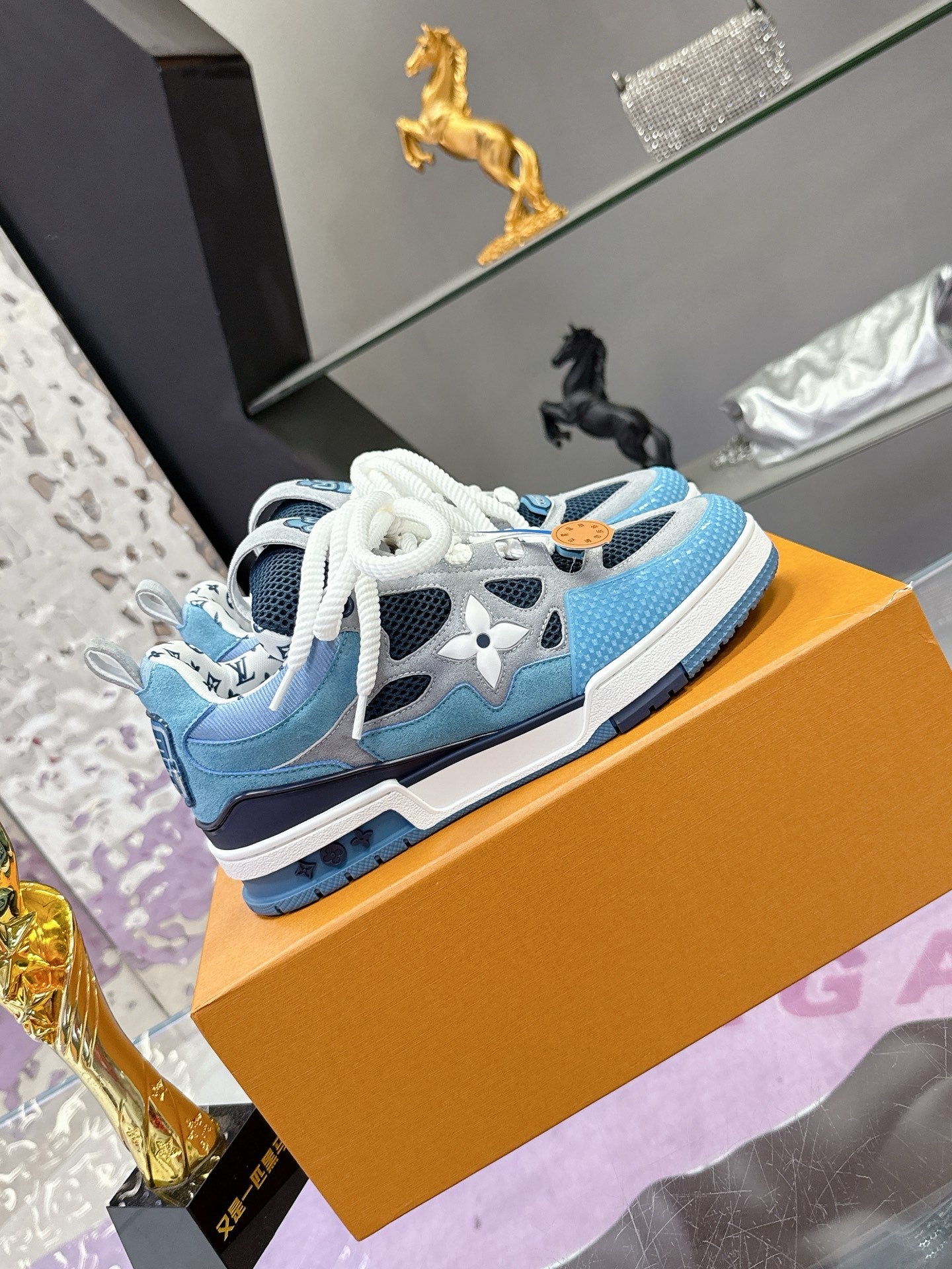Blue Louis Vuitton women’s sneakers with white laces and patterned side panels