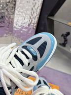 Close-up of blue Louis Vuitton women’s sneaker with white laces and logo patches