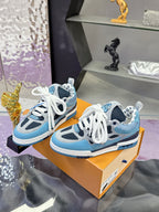Two blue Louis Vuitton women’s sneakers on orange box, white laces visible