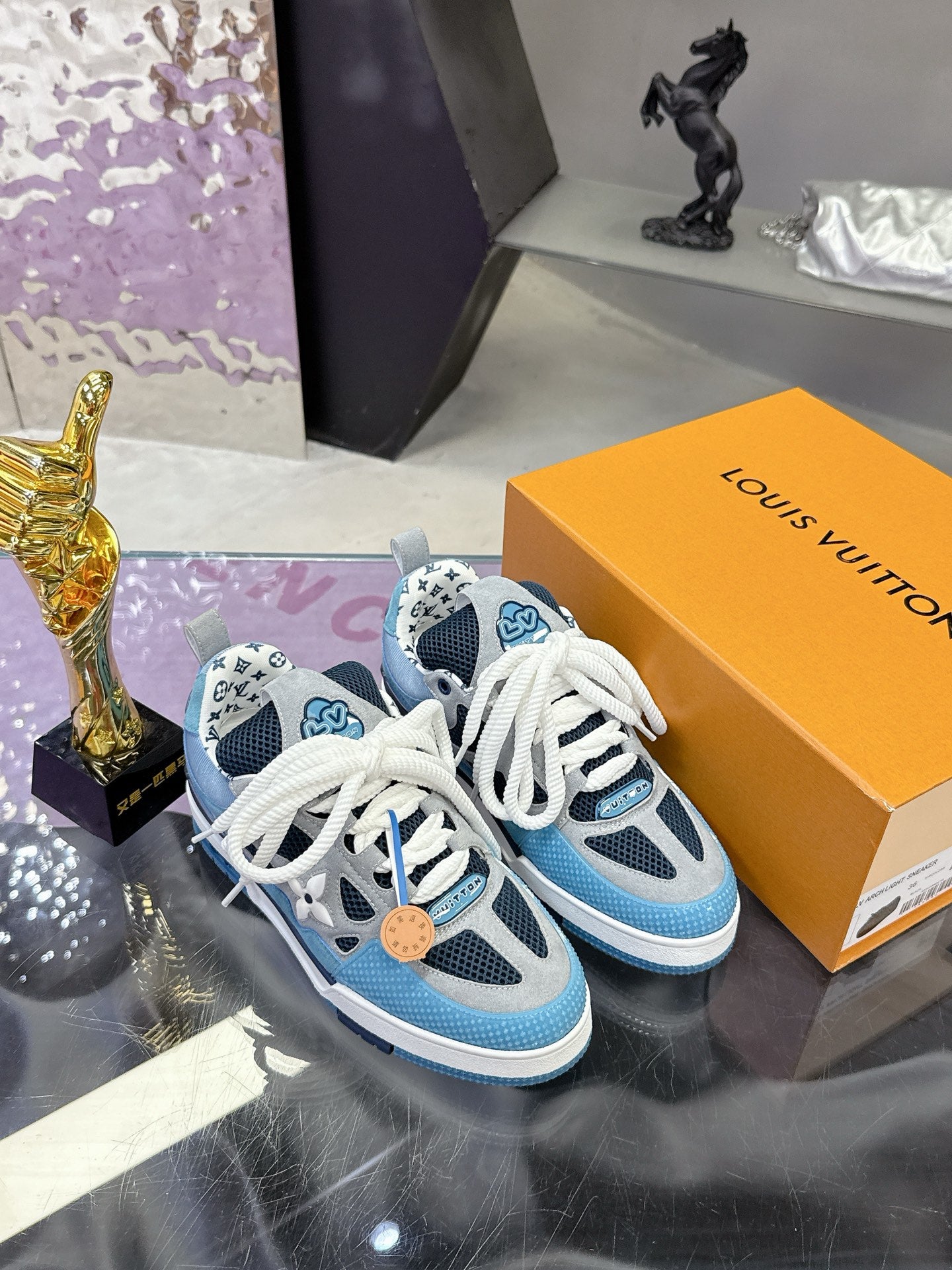 Blue Louis Vuitton women’s sneakers with white laces and tan logo tag