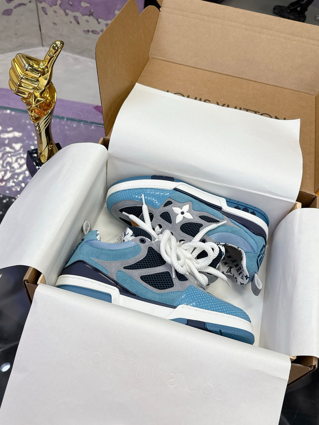 Blue Louis Vuitton women’s sneakers with white laces and black accents