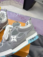 Gray low-top sneakers with white laces, side star emblem, and blue-trim sole