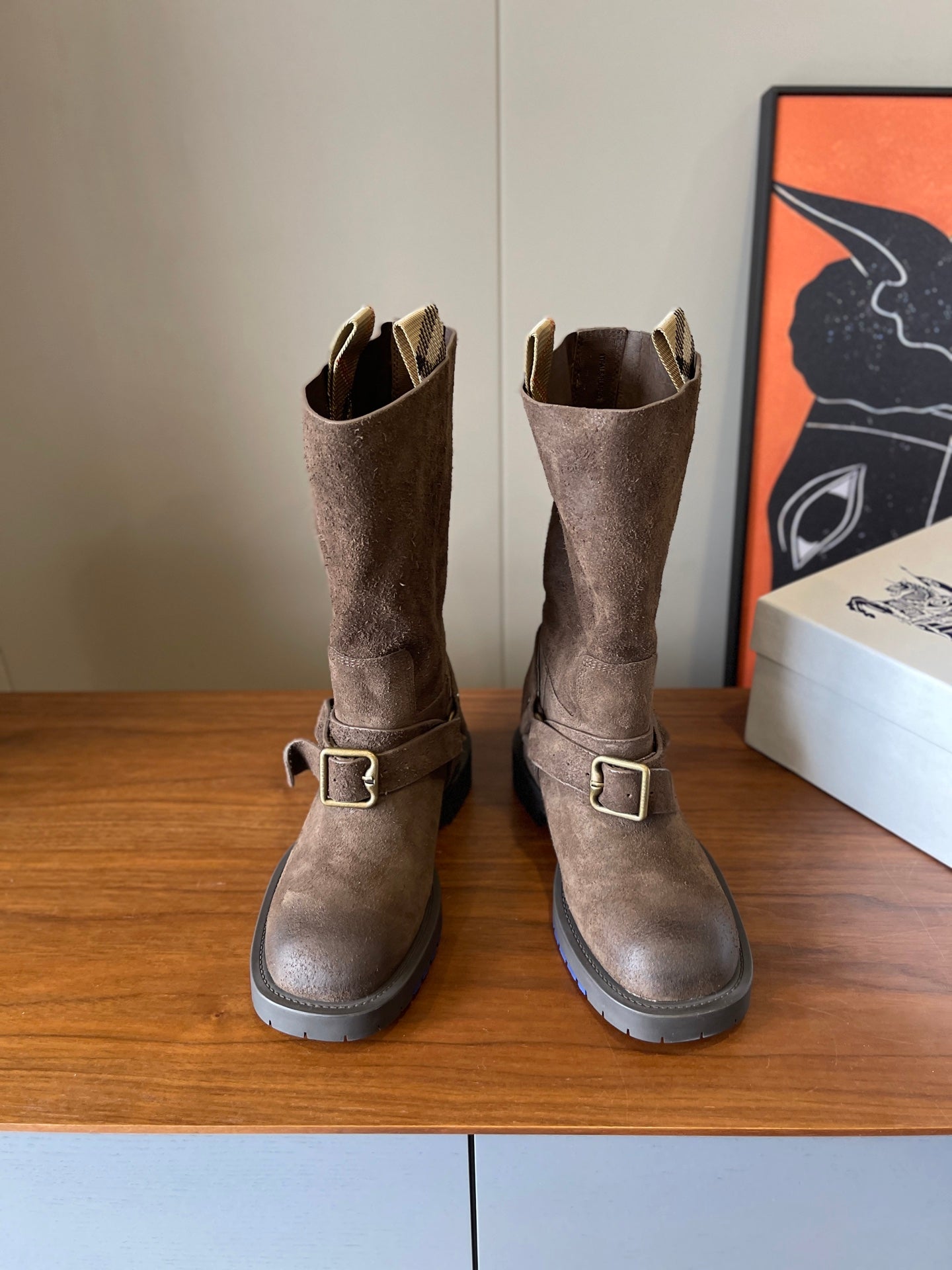 Suede ankle boots with gold-tone buckle straps and lug soles, taupe