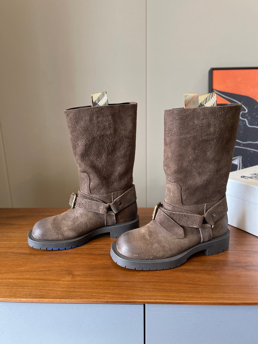 Suede ankle boots with gold-tone buckle straps and lug soles, taupe
