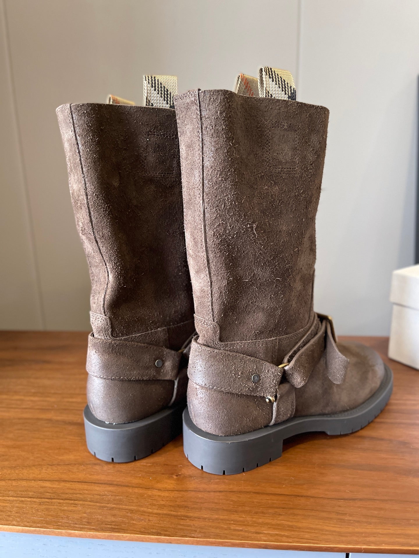 Pair suede ankle boots with ankle buckle straps and lug soles, taupe