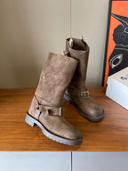 Pair of suede ankle boots with buckle straps and lug soles, taupe