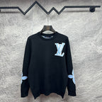 Dark navy crewneck sweater with Louis Vuitton monogram patch and light blue cuffs