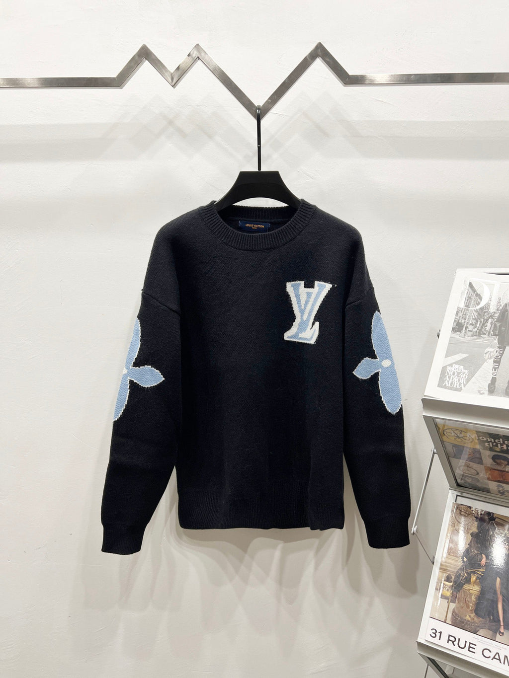 Dark navy crewneck sweater with Louis Vuitton logo on chest and light blue arm patches