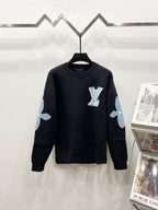 Dark navy crewneck sweater with Louis Vuitton logo on chest and light blue arm patches
