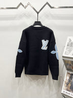 Dark navy crewneck sweater with Louis Vuitton logo and light blue sleeve patches