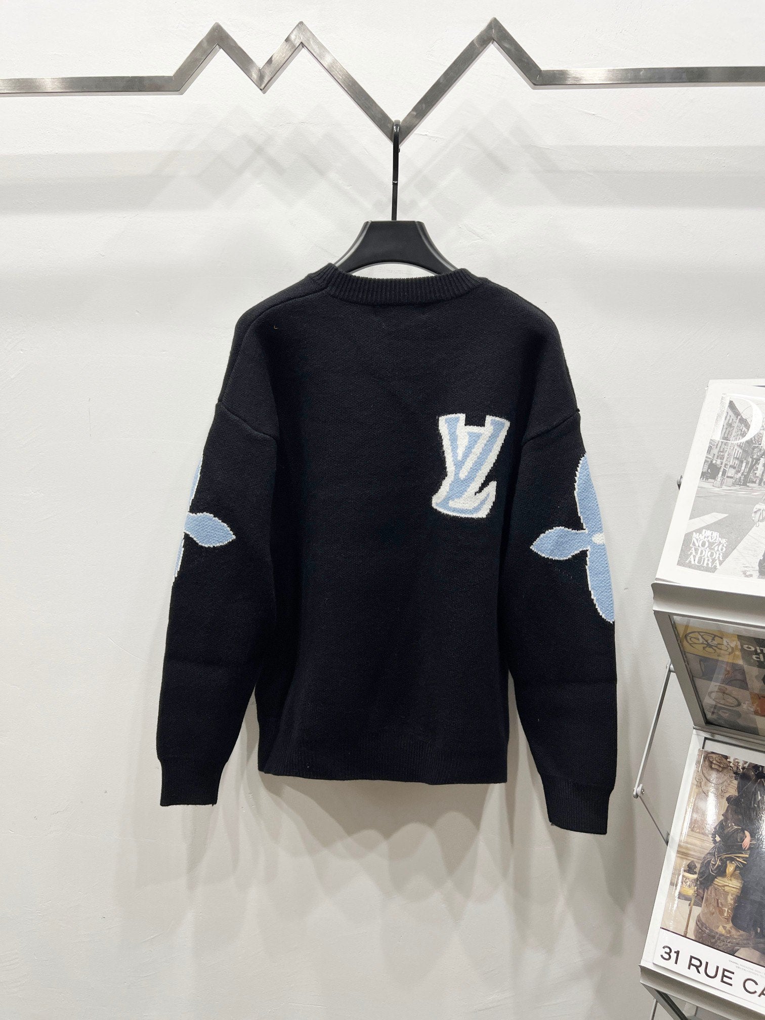 Dark navy crewneck sweater with Louis Vuitton logo and light blue sleeve patches