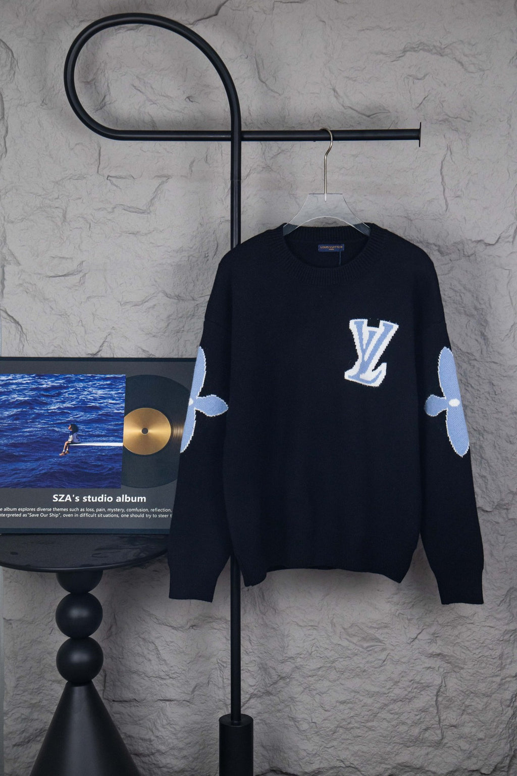 Dark navy crewneck sweater with Louis Vuitton logo on chest and light blue sleeve accents