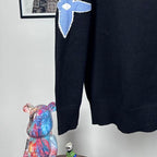 Louis Vuitton long-sleeve sweater with blue LV star logo on arm and ribbed hem