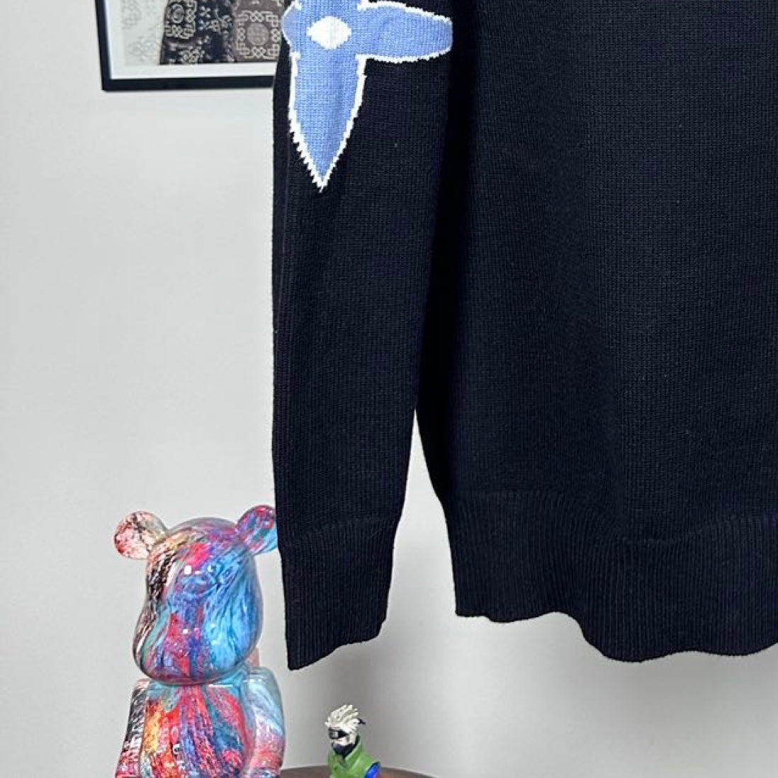 Louis Vuitton long-sleeve sweater with blue LV star logo on arm and ribbed hem