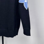Louis Vuitton long-sleeve sweater close-up of blue LV star logo on sleeve
