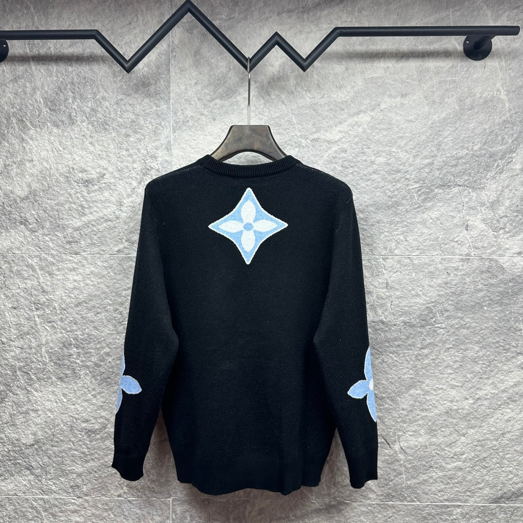Dark navy crewneck sweater with light blue diamond monogram on back and sleeve patches