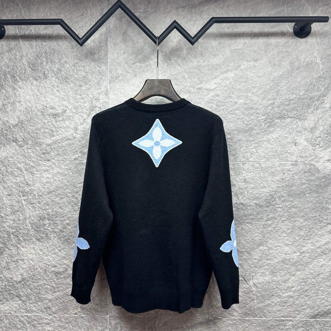 Dark navy crewneck sweater with light blue diamond monogram on back and sleeve patches