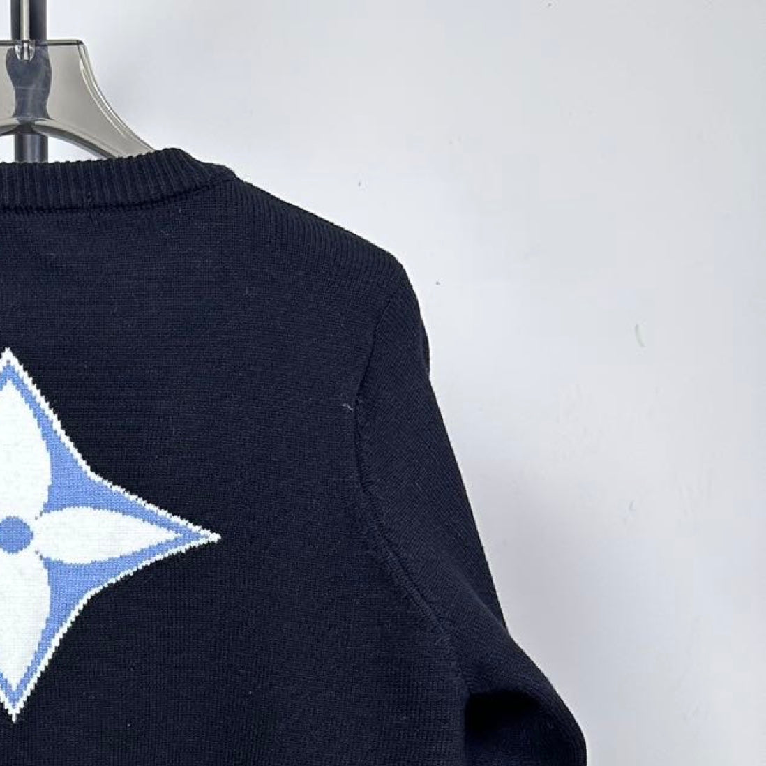 Louis Vuitton long-sleeve sweater close-up of blue LV star on upper back