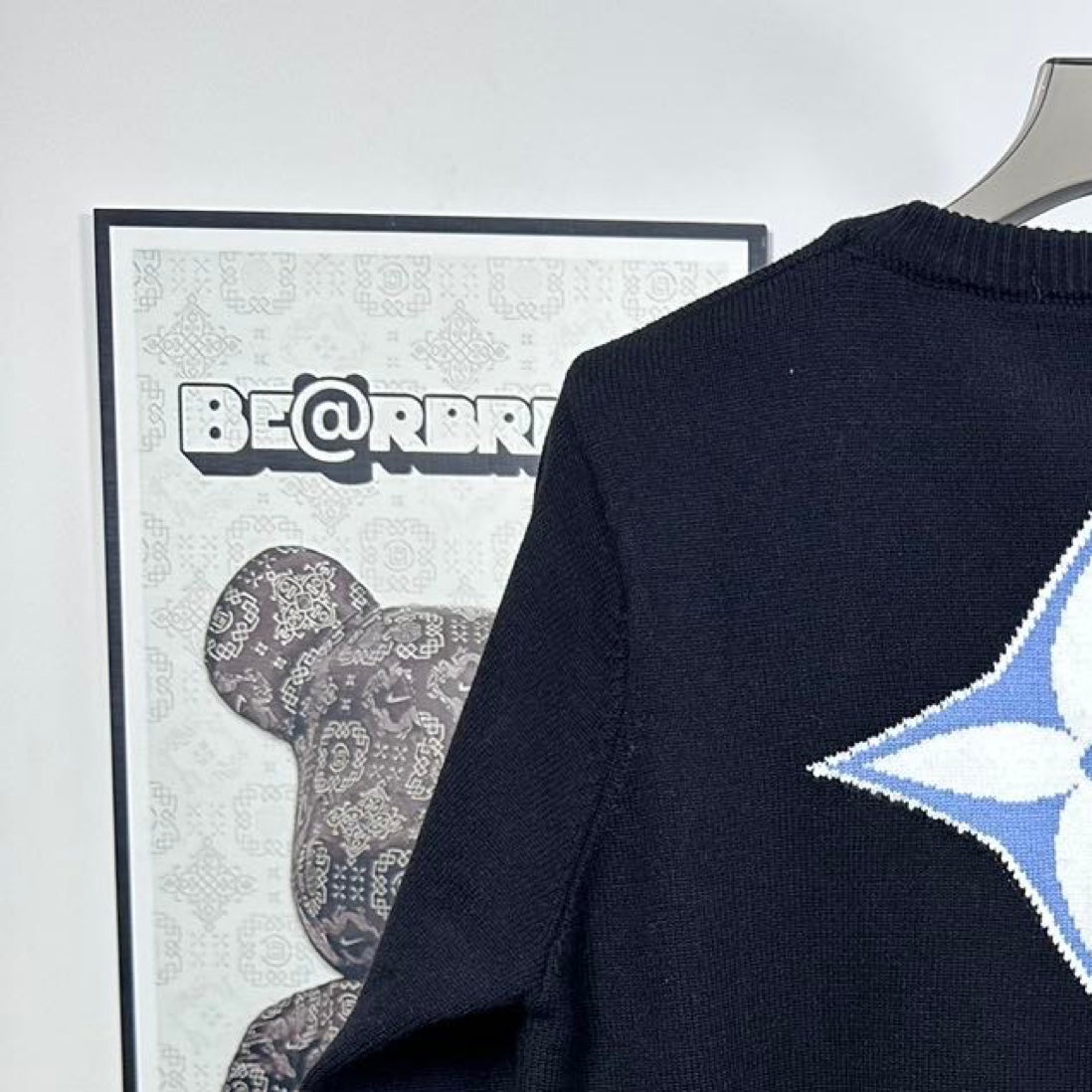 Louis Vuitton long-sleeve sweater close-up of blue LV star logo on back