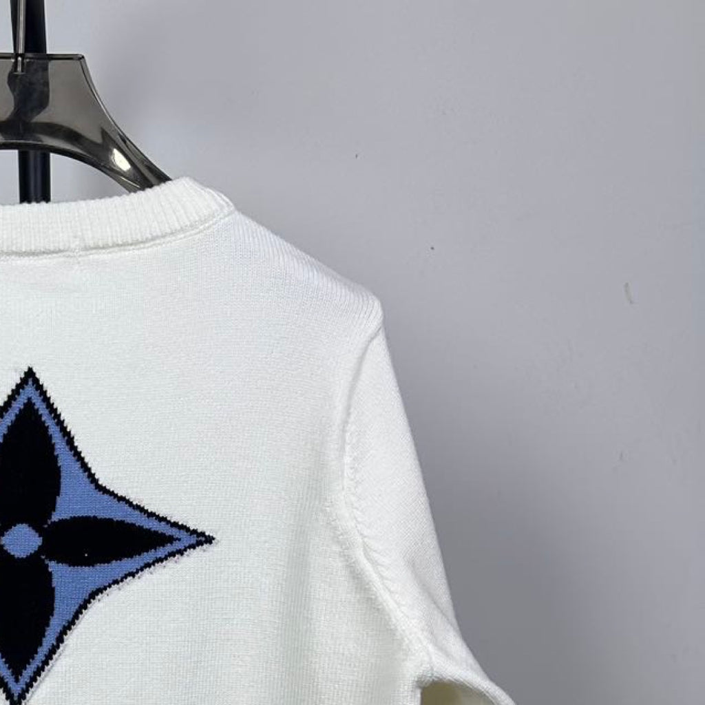 Back view long-sleeve knit sweater in white with blue star logo near shoulder