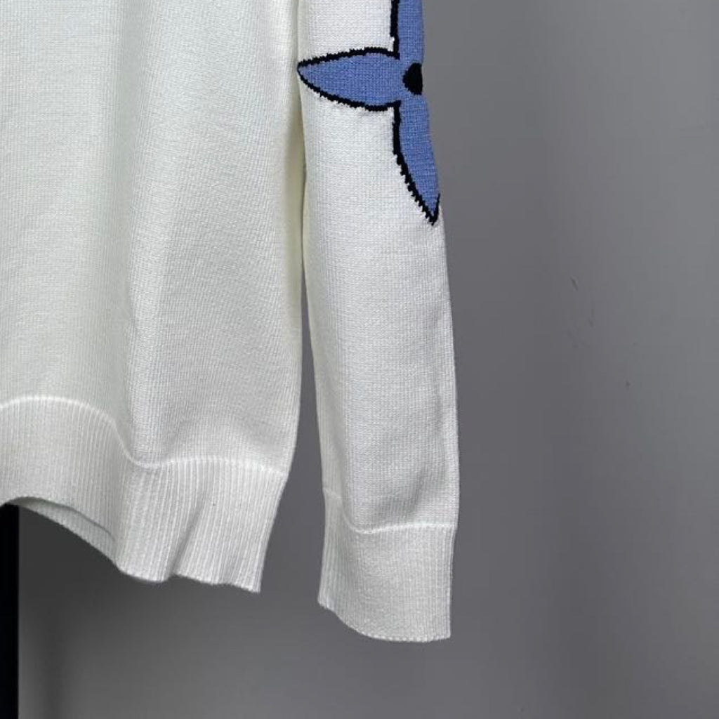 Long-sleeve knit sweater in white with blue logo on sleeve and ribbed cuffs