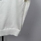 Long-sleeve knit sweater in white with ribbed lower hem and textured knit fabric