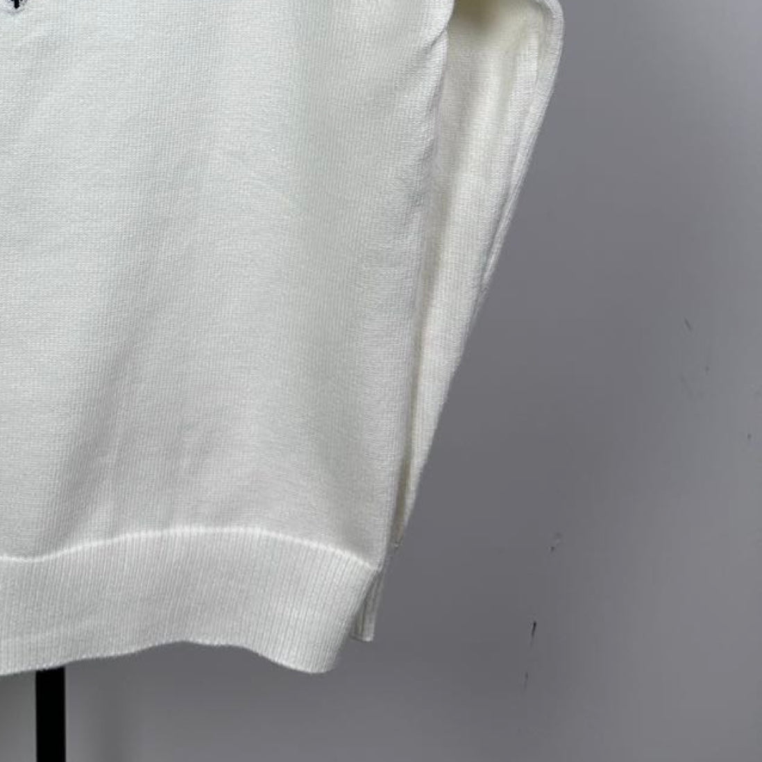 Long-sleeve knit sweater in white with ribbed lower hem and textured knit fabric