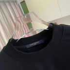 Black crewneck sweatshirt neckline with Louis Vuitton label