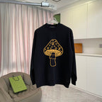 Black long-sleeve crewneck sweatshirt with yellow logo graphic on chest