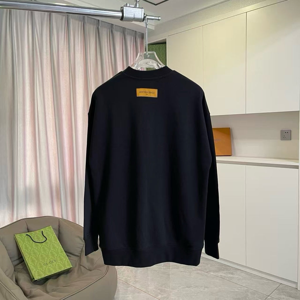 Black long-sleeve crewneck sweatshirt on hanger with yellow back tag