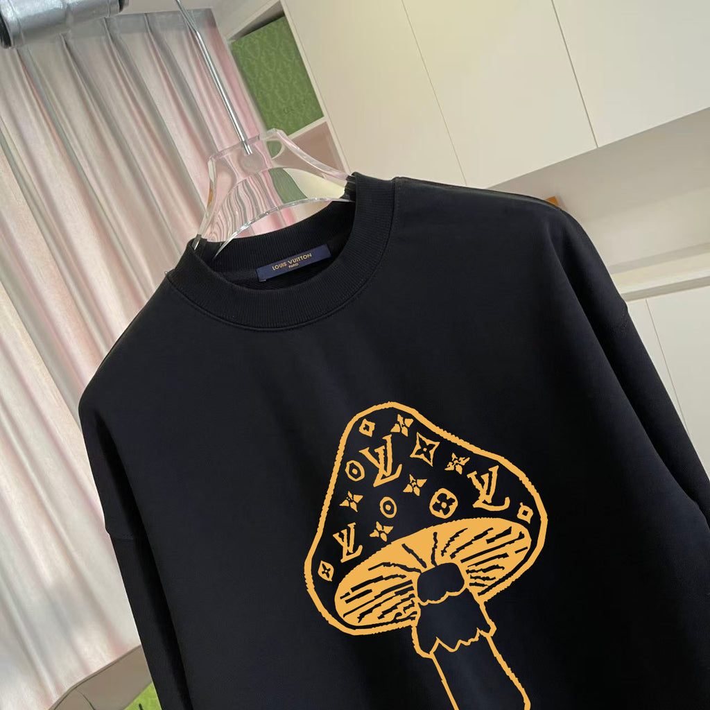 Black crewneck sweatshirt with yellow monogram-style graphic chest detail