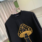 Black crewneck sweatshirt with yellow monogram-style graphic chest detail