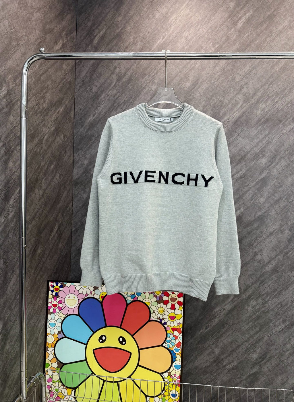 Light gray crewneck sweatshirt with black GIVENCHY text graphic on the front