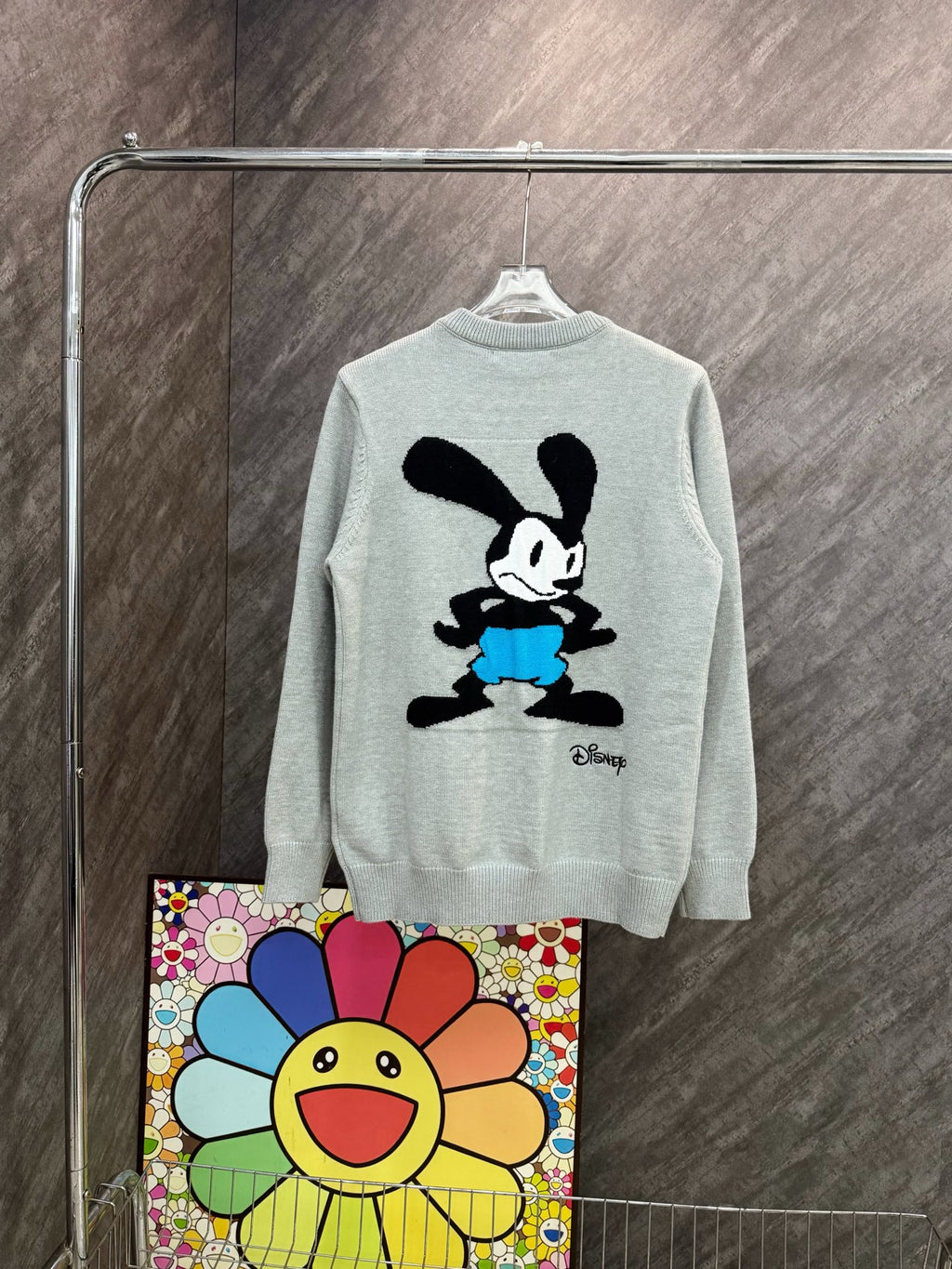Light gray crewneck sweatshirt with black Mickey Mouse graphic wearing blue shorts
