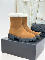 Tan suede ankle boots with white faux-fur cuff and lug rubber sole.