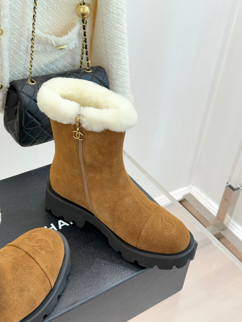 Tan suede mid-ankle boots with white faux-fur top and chunky lug sole.