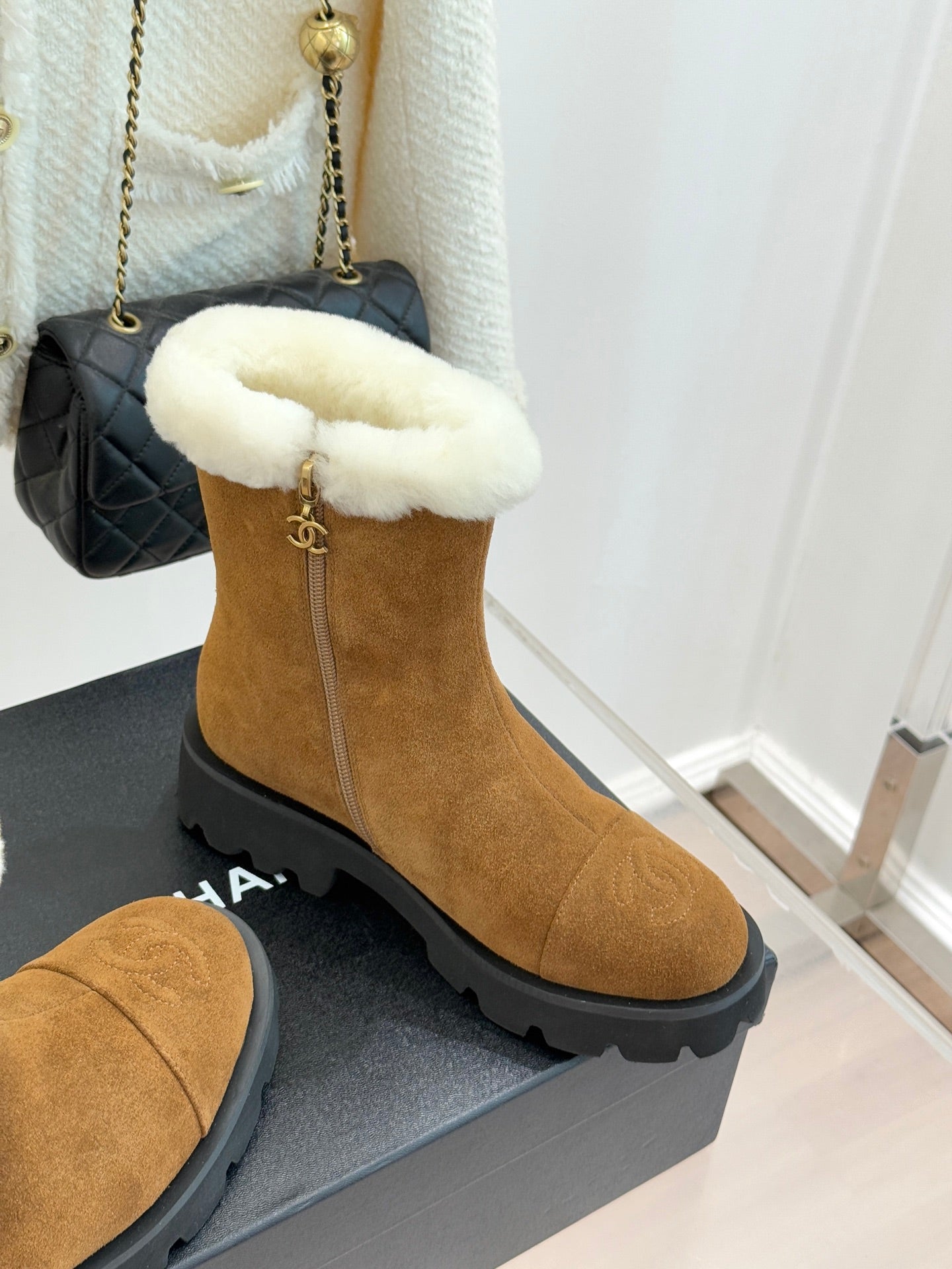 Tan suede mid-ankle boots with white faux-fur top and chunky lug sole.