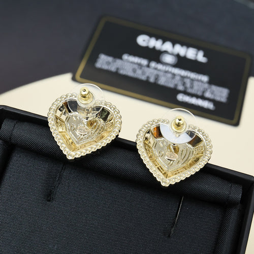 Gold-tone heart stud earrings with rhinestone border and circular center motif