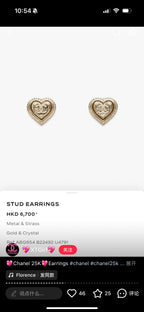 Gold-tone heart stud earrings with small rhinestone details on a plain background