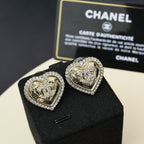 Gold-tone heart stud earrings with rhinestone halo and engraved center crest