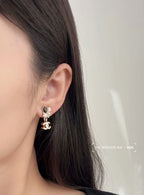 Chanel hoop earrings with logo charm and pearl accents, silver-tone with pink bead