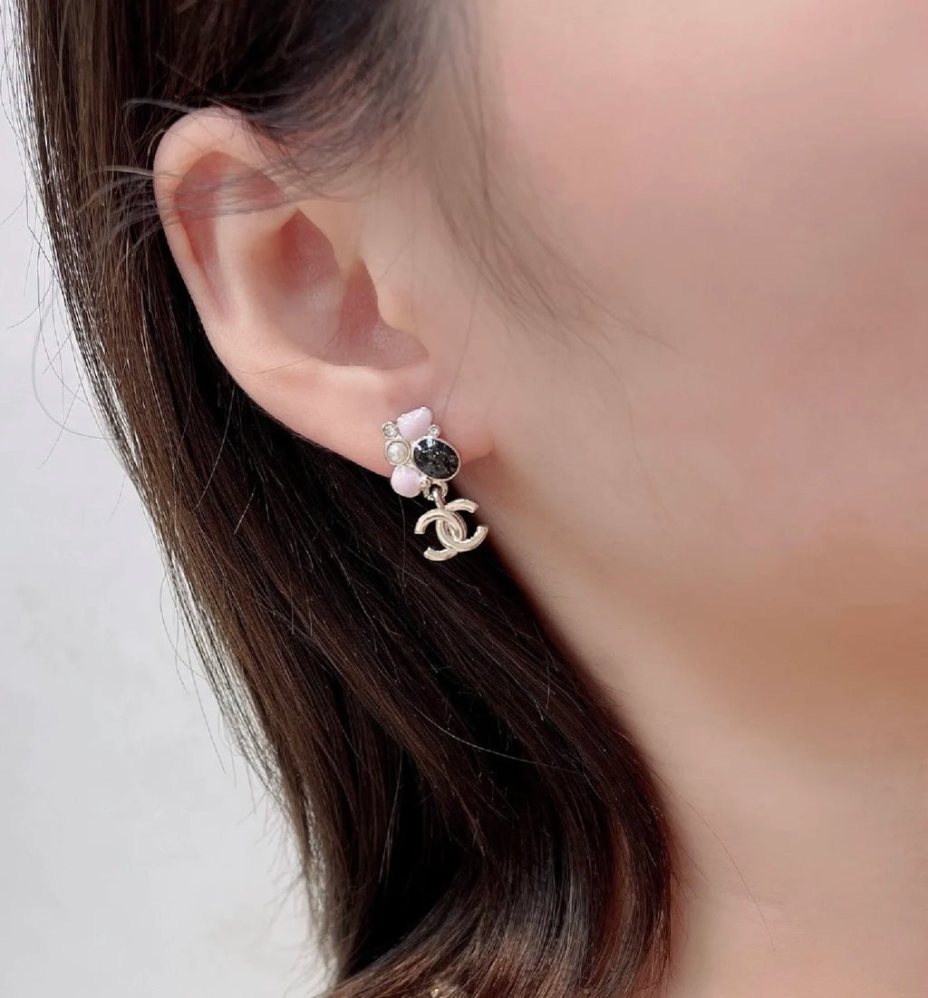 Chanel hoop earrings with pink bead, pearl accents, and logo charm, silver-tone