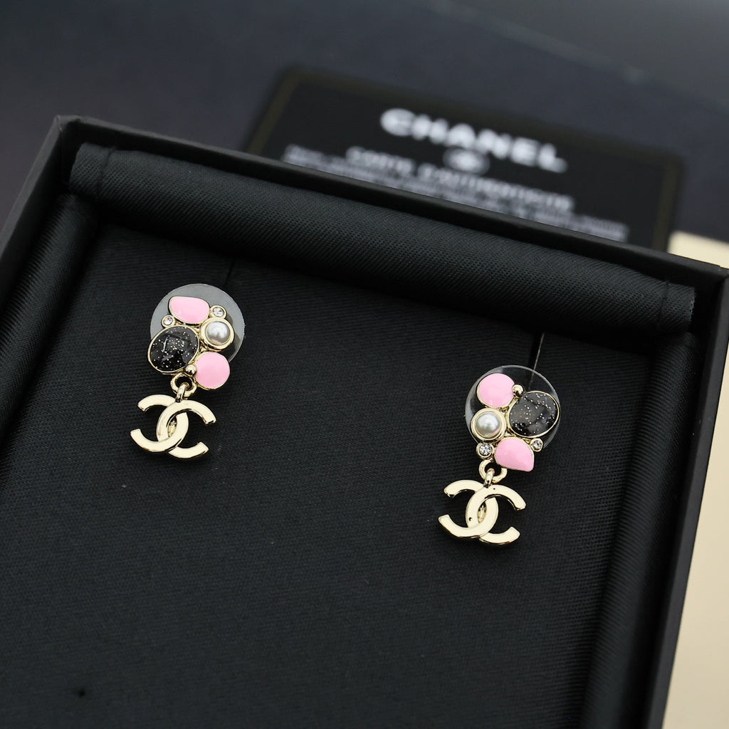Chanel drop earrings with pink beads, pearls, and black oval charm with logo
