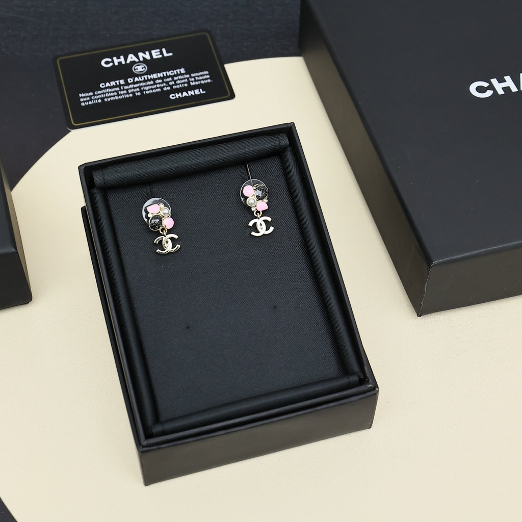 Chanel pair earrings on black jewelry box, silver-tone with pink bead and pearl charms