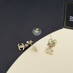 Chanel dangle earrings with gold-tone studs and floral cluster charms