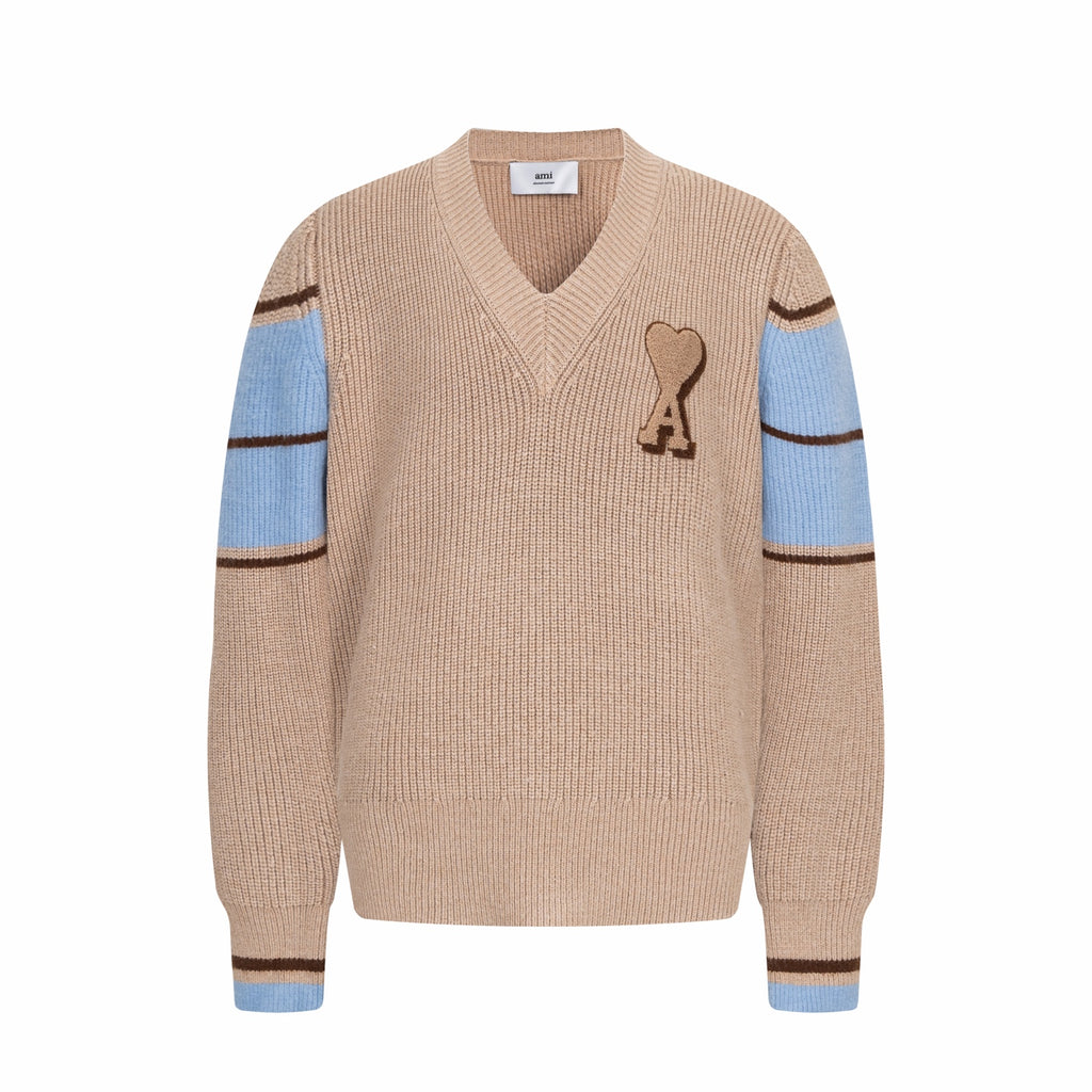 Beige knit V-neck sweater with heart A patch and blue striped cuffs