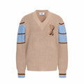 Beige knit V-neck sweater with heart A patch and blue striped cuffs