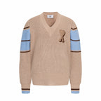 Beige knit V-neck sweater with heart A patch and blue striped cuffs