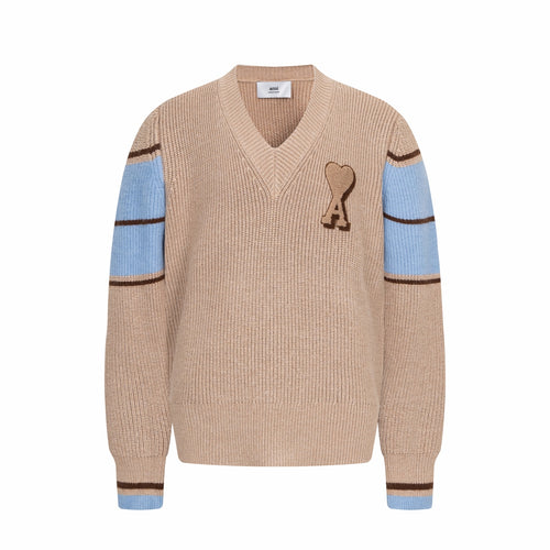 Beige knit V-neck sweater with heart A patch and blue striped cuffs