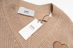 Beige knit sweater with Ami hang tags and ribbed V-neck detail